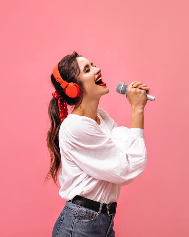 Girl singing with headphones and a microphone
